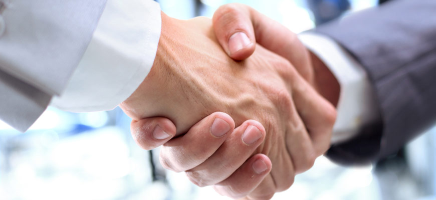 Two people shake hands in business agreement